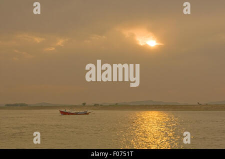 ASIA, MYANMAR (BURMA), Bagan, Irrawaddy River, ferry boat on river as sun sets Stock Photo