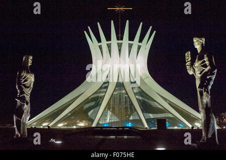 Brasilia, DF, Brazil. The Metropolitan Cathedral of Nossa Senhora Aparecida at night with statues of the evangelists guarding the entrance. Stock Photo
