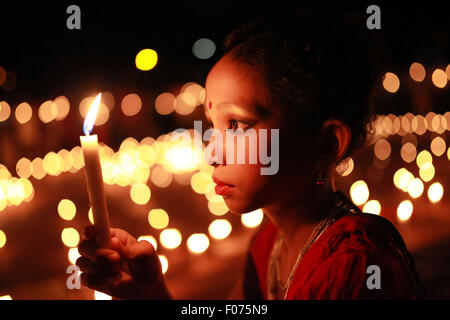 Dhaka, Bangladesh. 8th August, 2015. A girl holds a candle at a celebration ahead of the August 9 International Day of the World's Indigenous Peoples in Dhaka on August 8, 2015.  This year United Ntions make slogan for ths day is 'Ensuring indigenous peoples' health and well-being'. Credit:  zakir hossain chowdhury zakir/Alamy Live News Stock Photo