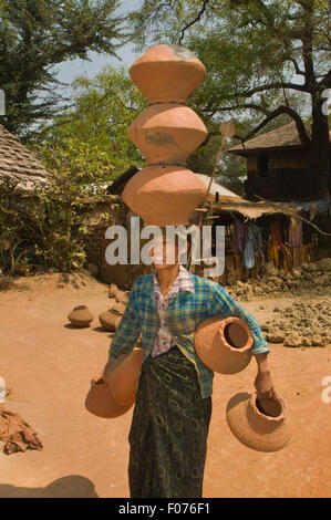 ASIA, MYANMAR (BURMA), Mandalay, woman with clay pots on her head Stock Photo