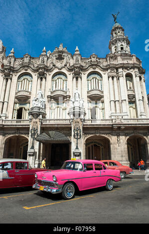 HAVANA, CUBA - JUNE 13, 2011: Bright pink vintage American car stands parked in front of the landmark Great Theater of Havana. Stock Photo