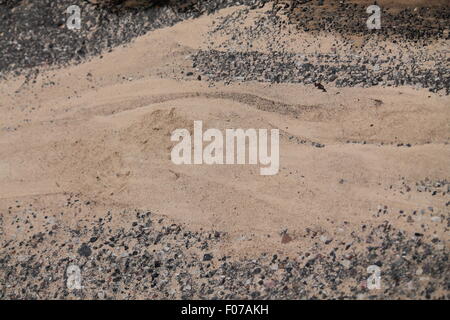 waves of light brown sand color lay on stone road Stock Photo