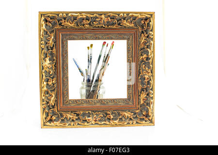 Frame and old brushes isolated on white. Stock Photo