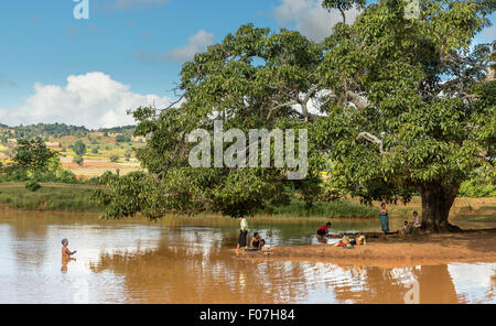 Women bathing and washing clothes in a muddy lake along the main road from Pindaya to Shwe Nyaung in Shan State. Stock Photo