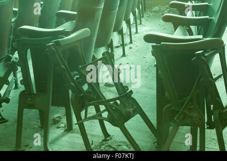 Decaying theater seats in soft sunshine. Stock Photo