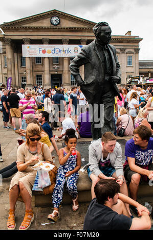 The statue of former Prime Minister Harold Wilson, who was born in Huddersfield, looks out over the  crowds at the annual Huddersfield Food and Drink Festival held in St Georges Sq, Huddersfield, West Yorkshire, UK.  Sunday  9th August 2015 Stock Photo