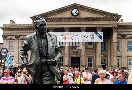 The statue of former Prime Minister Harold Wilson, who was born in Huddersfield, looks out over the  crowds at the annual Huddersfield Food and Drink Festival held in St Georges Sq, Huddersfield, West Yorkshire, UK.  Sunday  9th August 2015 Stock Photo