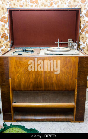 British circa 1950 'Sound sales' radiogram wooden cabinet. Open lid with the radio station selection dial and record player turntable. Stock Photo