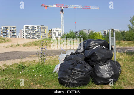 Black plastic bags with garbage are thrown out in not put place. A crime against the nature concept. Sunny summer day landscape Stock Photo