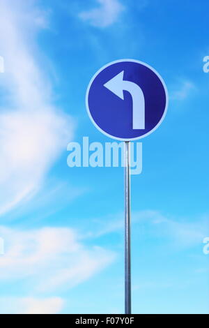 left turn traffic sign over blue sky Stock Photo