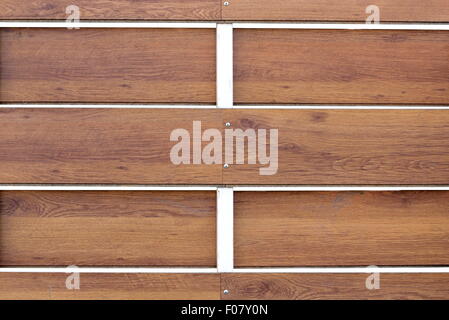 closeup of a textured wooden fence with metal pillar painted white Stock Photo