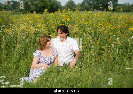 A Loving couple relaxing on a meadow Stock Photo