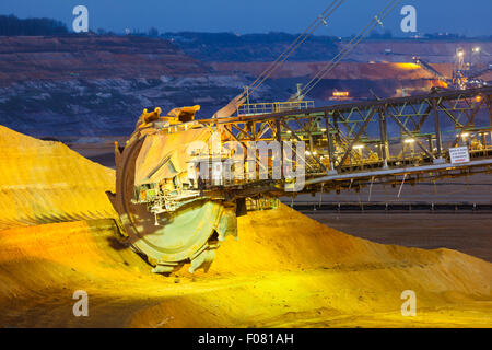 A giant Bucket Wheel Excavator in a lignite pit mine at night Stock Photo