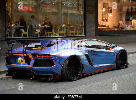 A Lamborghini Aventador with a Tron design cutomised by Oakley Design parked on double yellow lines in Manchester City Centre. Stock Photo