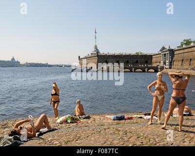 People relaxing at Neva beach in St. Petersburg, Russia Stock Photo