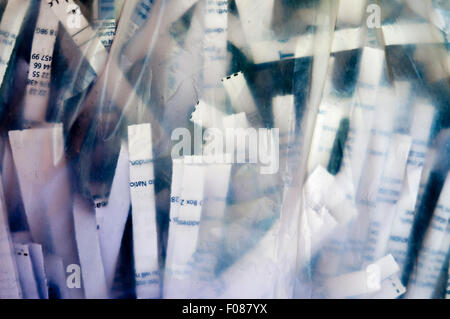 Securely shredded paper seen through the side of a transparent plastic bag. Stock Photo