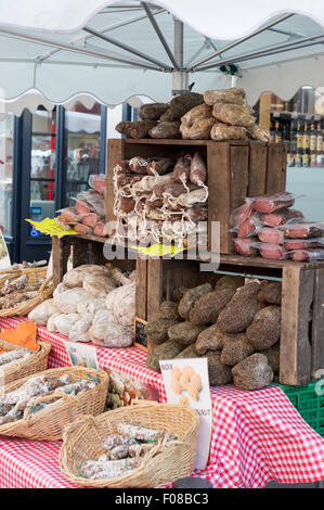 Market stall in Bayeux, France selling cured sausages Stock Photo