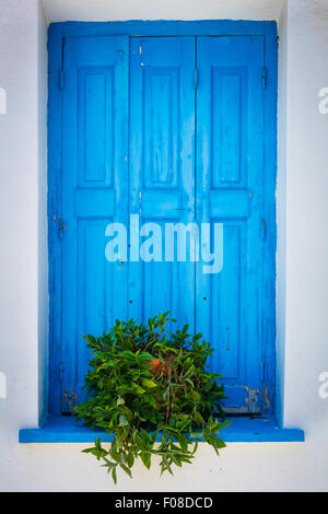 Window shutter in characteristic blue on white colors in Kokkari on the Greek Island of Samos. Stock Photo