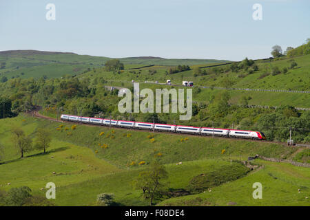 A Virgin Pendolino heads north through the Lune Gorge on the morning of 11th June 2015. Stock Photo