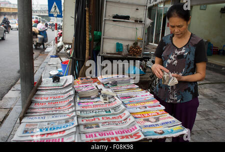 A Vietnamese woman selling newspapers in Ho Chi Minh city in Vietnam ...