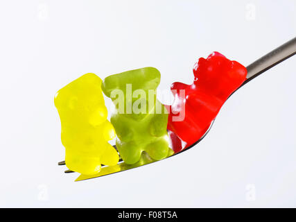 Three gummy bears on a fork Stock Photo