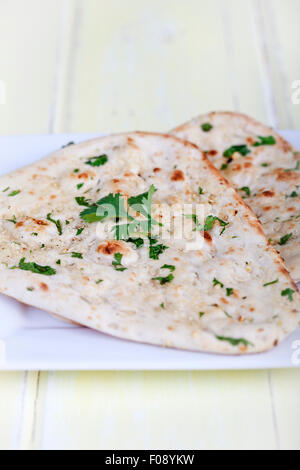 Traditional fresh baked naan bread with corriander Stock Photo