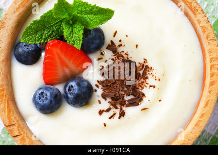 Smooth semolina porridge served with fresh fruit and grated chocolate Stock Photo