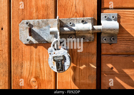 Metal bolt and padlock on a garden shed door Stock Photo