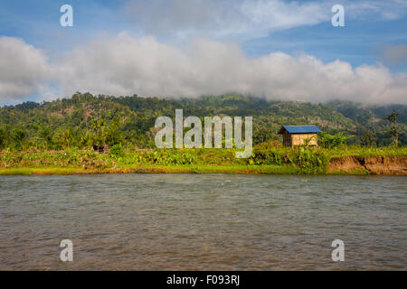 Agricultural land and a farming hut on the bank of a river near Lubuk Sikaping, Pasaman, West Sumatra, Indonesia. Stock Photo