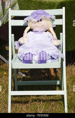 Doll sitting on wooden chair at the Ellingham & Ringwood Agricultural Society Annual Show at Hampshire, UK in August Stock Photo