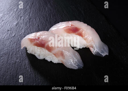 two sushi on flat slate, black background Stock Photo