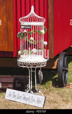 And they lived happily ever after sign and cage outside red wagon that can be hired Stock Photo