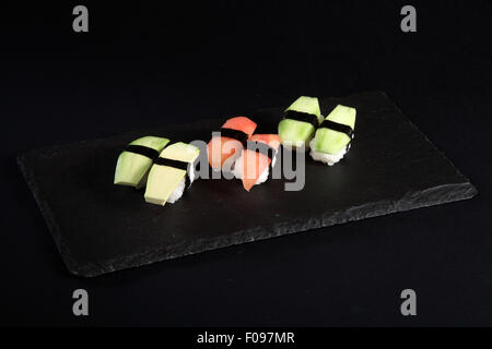 Vegetable sushi on flat slate, black background Stock Photo