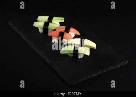 Vegetable sushi on flat slate, black background Stock Photo