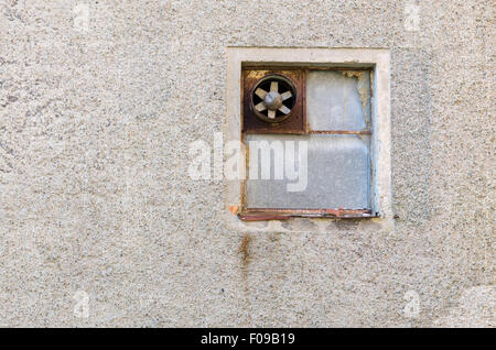 one old ventilation fan on the wall on a very old building Stock Photo