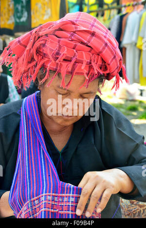 Pa-O woman market trader wearing the traditional plaid turban and Shan state bag Loikaw market, Myanmar, (Burma), Asia Stock Photo