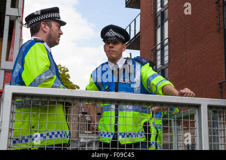 Metropolitan Police officers wearing high-visibility jackets on duty in London Stock Photo