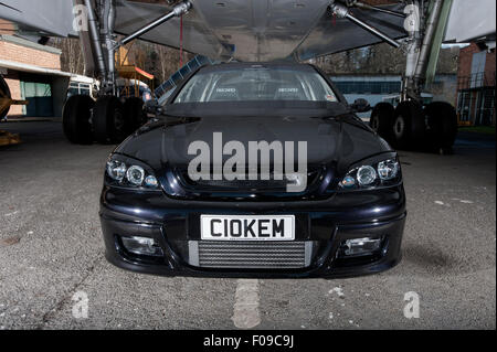 Modified Mk3 Vauxhall Astra car parked under a Concorde airliner Stock Photo