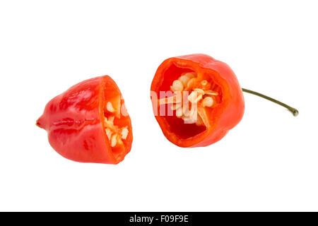 Close-up of a ripe red habanero chili cut in half, isolated on white background. Stock Photo