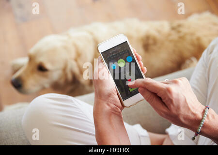 Woman Looking At Health Monitoring App On Smartphone Stock Photo