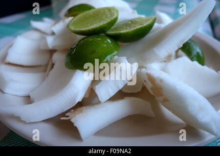 A plate of young coconut meat with lime. Stock Photo