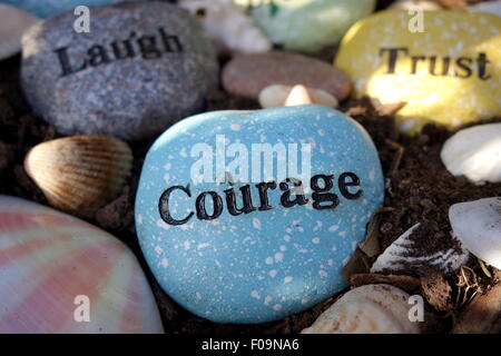 Inspirational quotes on garden rocks. Stock Photo