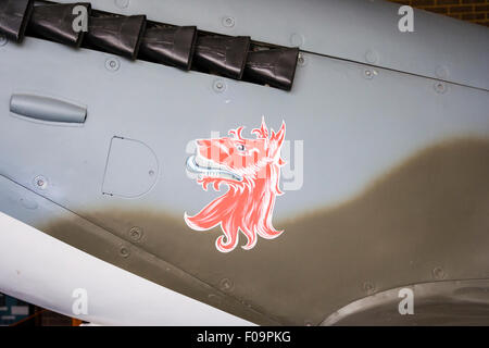 A Supermarine Spitfire Mk XVI (LF) . Close up detail of red dog emblem painted on the side of the fuselage under the engine exhaust. Stock Photo