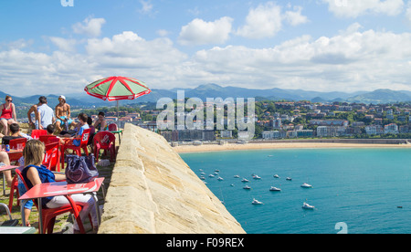 View over bay and Concha beach and San Sebastian (Donostia), from bar on Monte Urgull. Basque Country, Spain Stock Photo