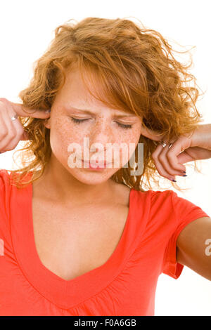 Young frustrated woman closing her ears with her hands Stock Photo