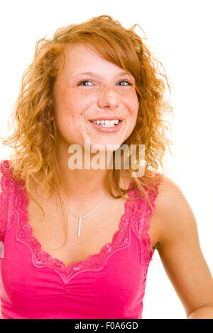 Young happy redhaired woman chewing bubble gum Stock Photo