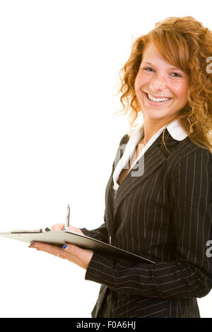 Young smiling redhaired woman holding a clipboard Stock Photo