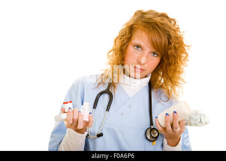 Young redhaired woman in lab coat with medical supplies Stock Photo