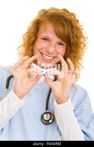 Young woman in lab coat breaking a cigarette in half Stock Photo
