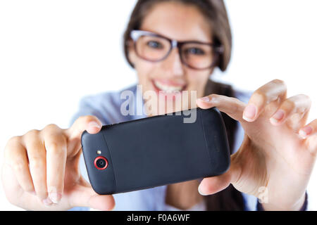 Cute brunette woman taking photo of herself. Isolated. Stock Photo